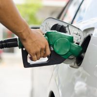 Refueling Car With Gasoline Pump Nozzle, Selective Focus on pump nozzle