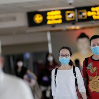 People wearing masks walk at Bandaranaike International Airport after Sri Lanka confirmed the first case of coronavirus in the country, in Katunayake, Sri Lanka January 30, 2020. REUTERS/Dinuka Liyanawatte