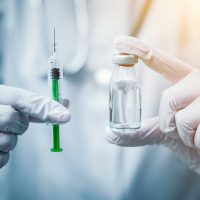 Syringe, medical injection in hand. Vaccination equipment with needle.