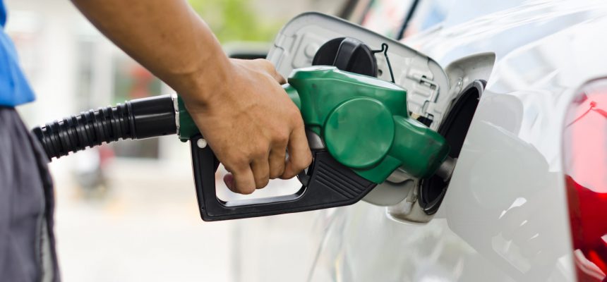 Refueling Car With Gasoline Pump Nozzle, Selective Focus on pump nozzle